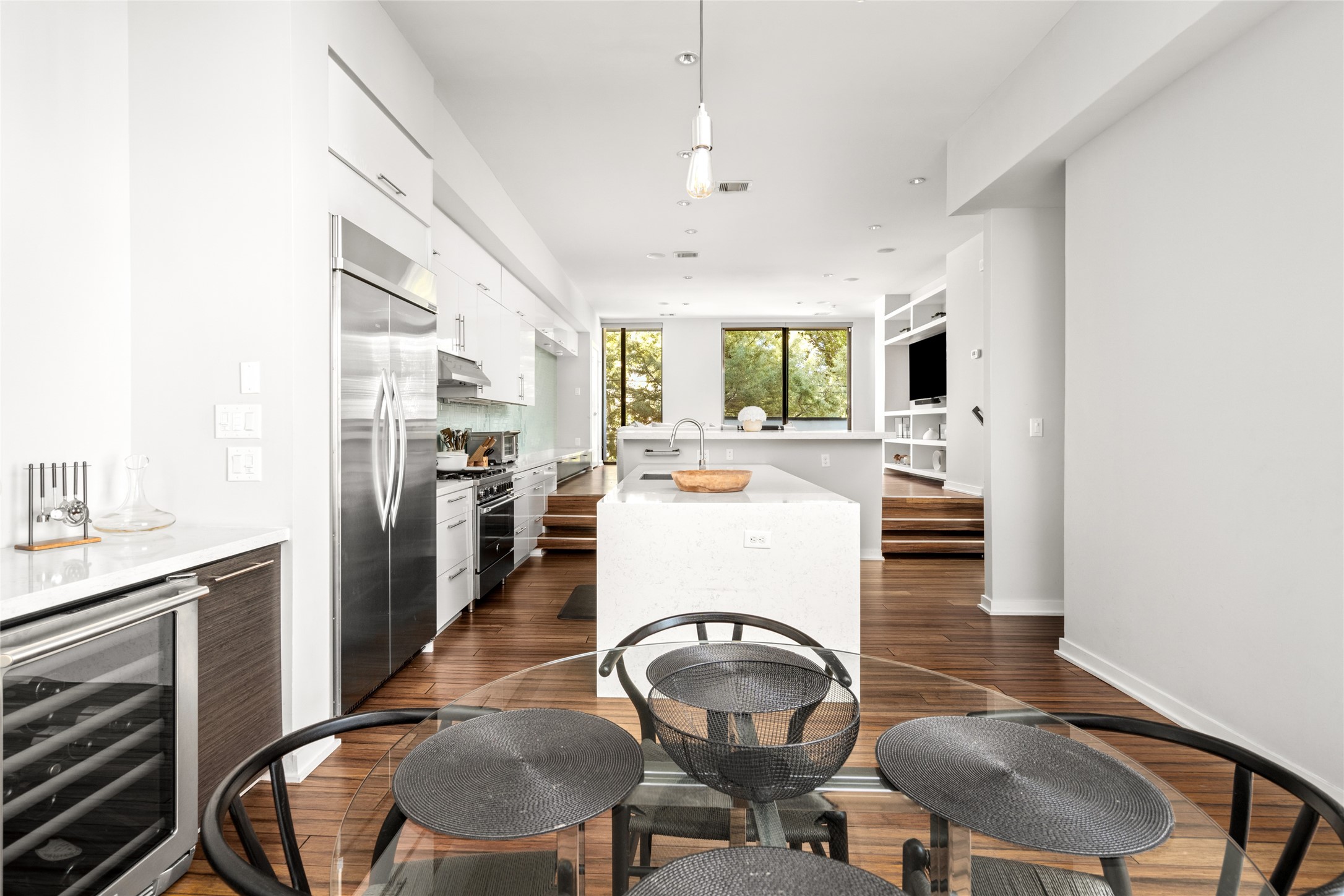 2202 Whitney Street Houston, TX 77006 - Photo 21 of 40 a kitchen with sink refrigerator dining table and chairs