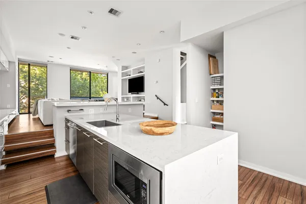 a view of kitchen with sink microwave and stove