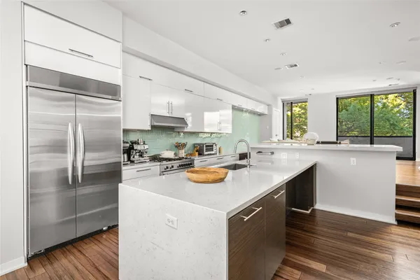 a kitchen with a sink stove and refrigerator