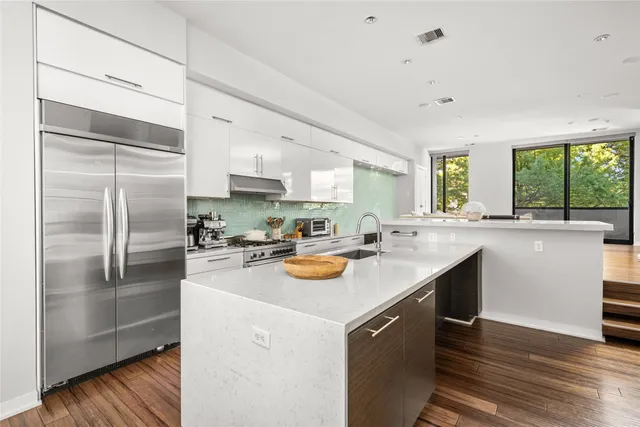 a kitchen with a sink stove and refrigerator
