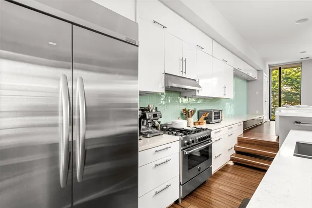 a kitchen with a refrigerator and a stove