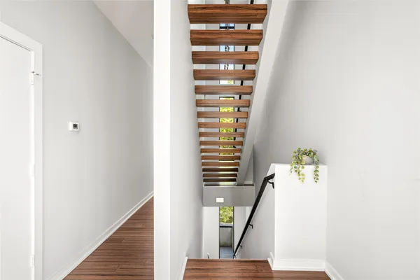 a view of entryway and hall with wooden floor