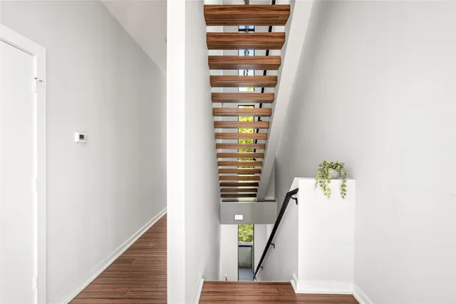 a view of entryway and hall with wooden floor