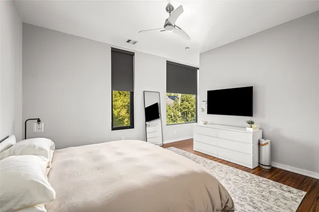 a bedroom with a bed and a flat screen tv