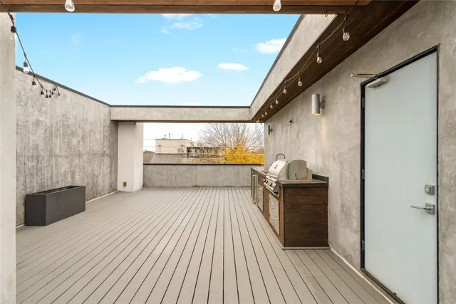 a open kitchen with a sink and refrigerator