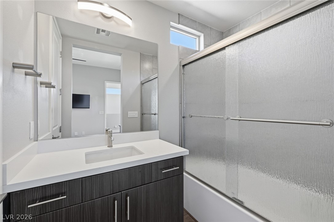 4246 Swift Street Las Vegas, NV 89135 - Photo 34 of 71 Bathroom featuring vanity and enclosed tub / shower combo