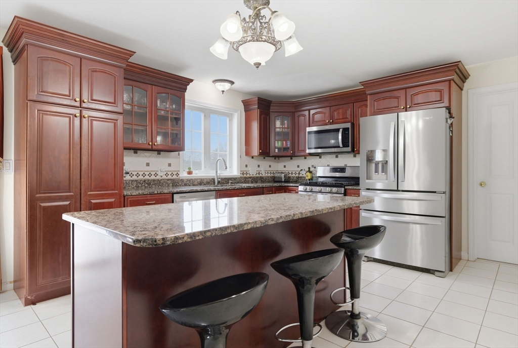 16 Windsor Road Shirley, MA 01464 - Photo 2 of 29 a kitchen with kitchen island a counter top space appliances and cabinets