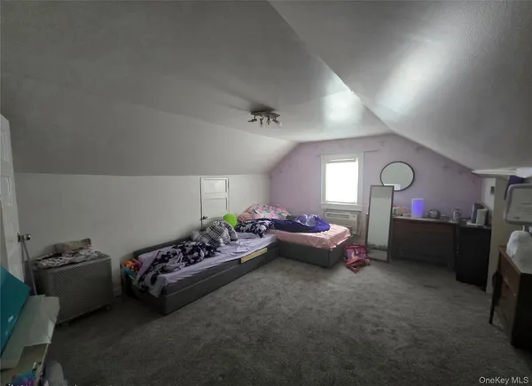 a bedroom with bed and a couch