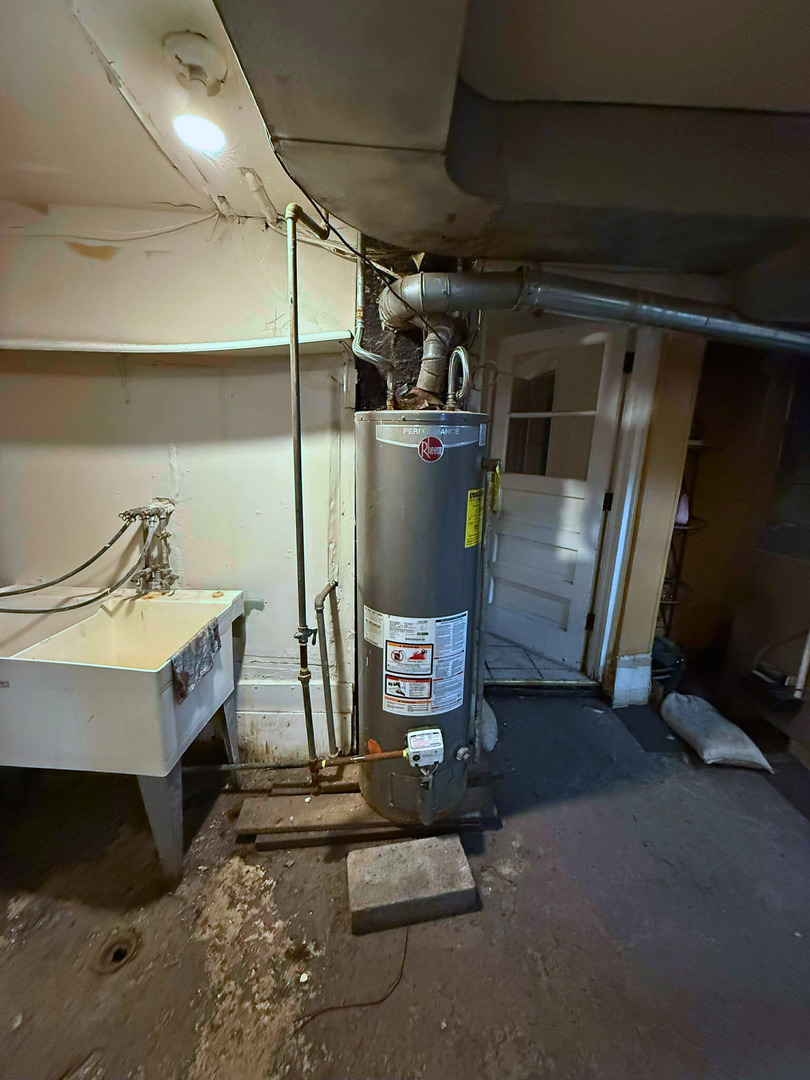 2038 West 70th Place Chicago, IL 60636 - Photo 6 of 8 a room with water heater and racks