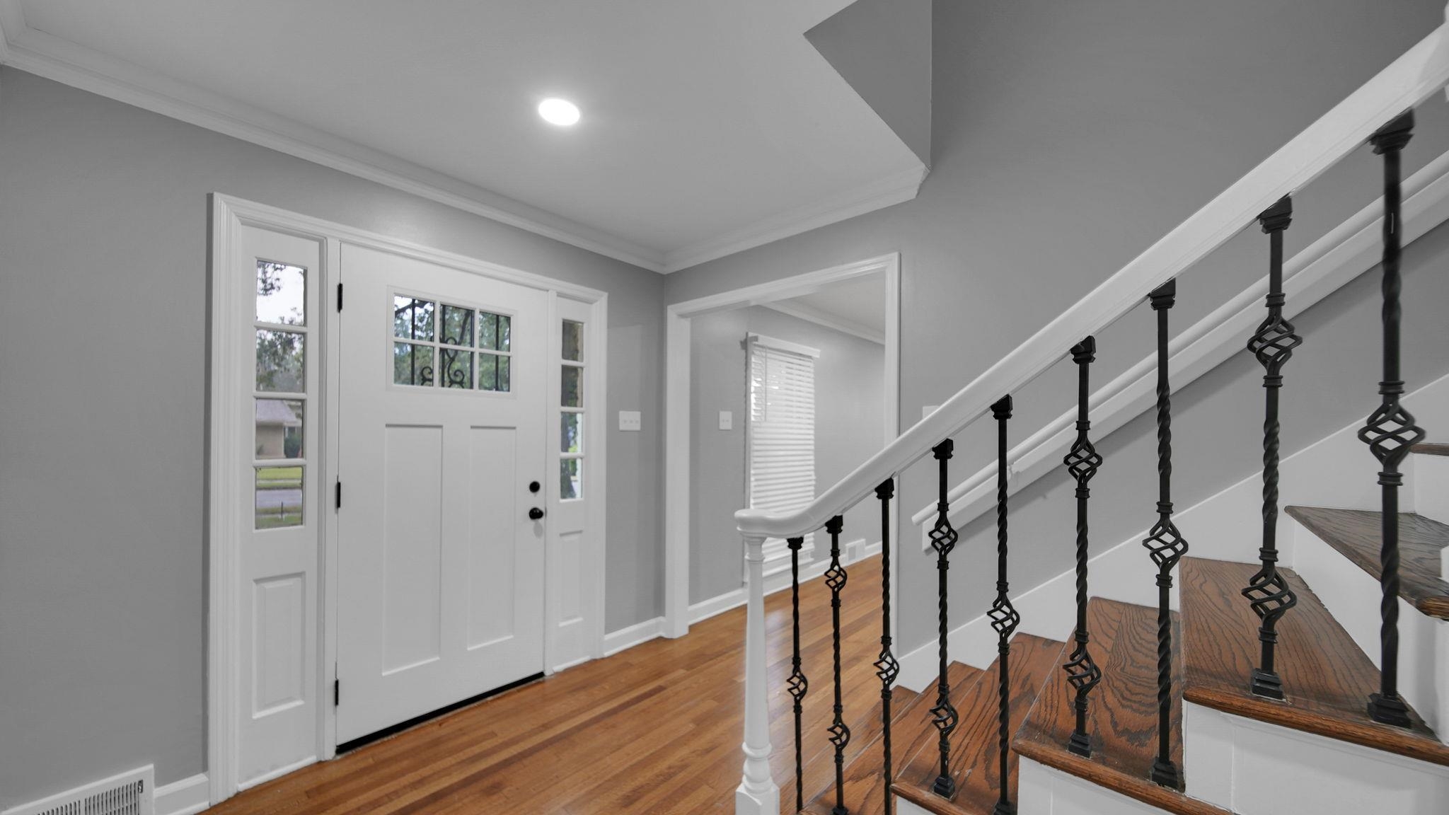 5256 Collingwood Road Memphis, TN 38117 - Photo 8 of 40 Foyer entrance featuring ornamental molding, stairs, and wood finished floors