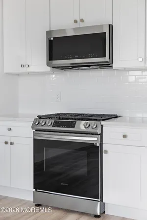 a stove top oven sitting inside of a kitchen