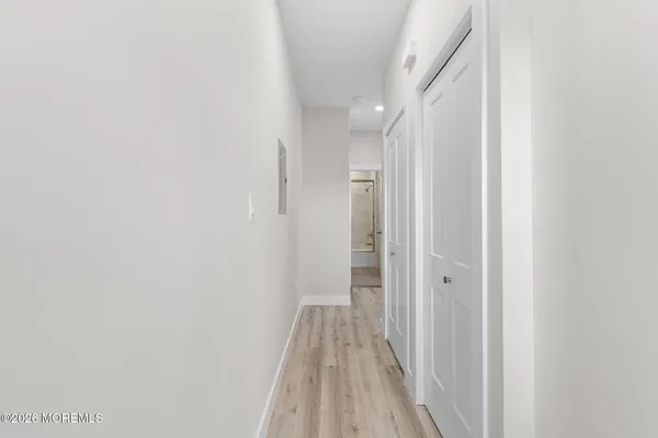 a view of a room with wooden floor and a bathroom