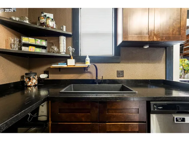 a kitchen with a sink cabinets and a window