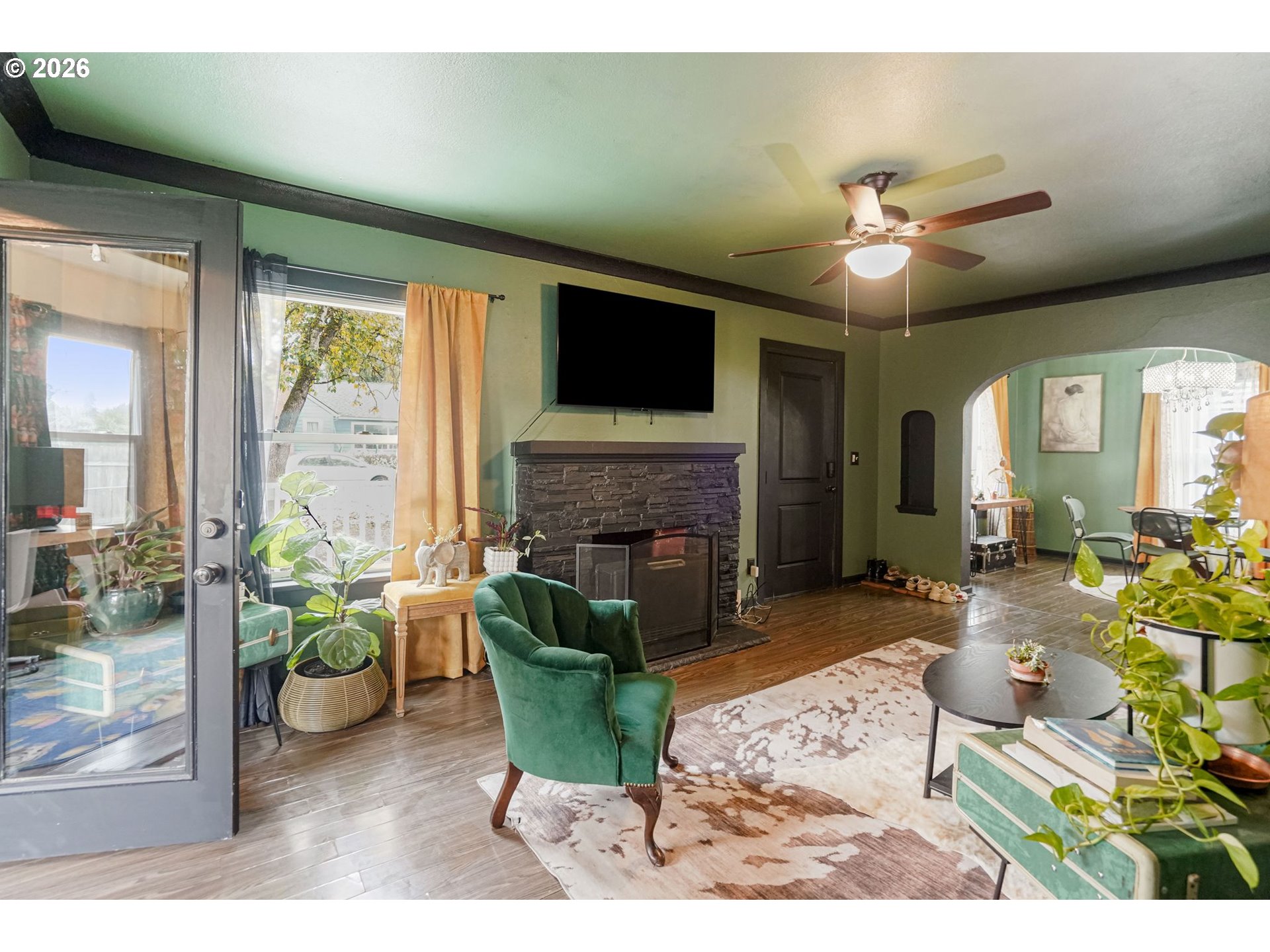 4810 Rickman Road Northeast Keizer, OR 97303 - Photo 18 of 42 a living room with furniture a flat screen tv and a fireplace