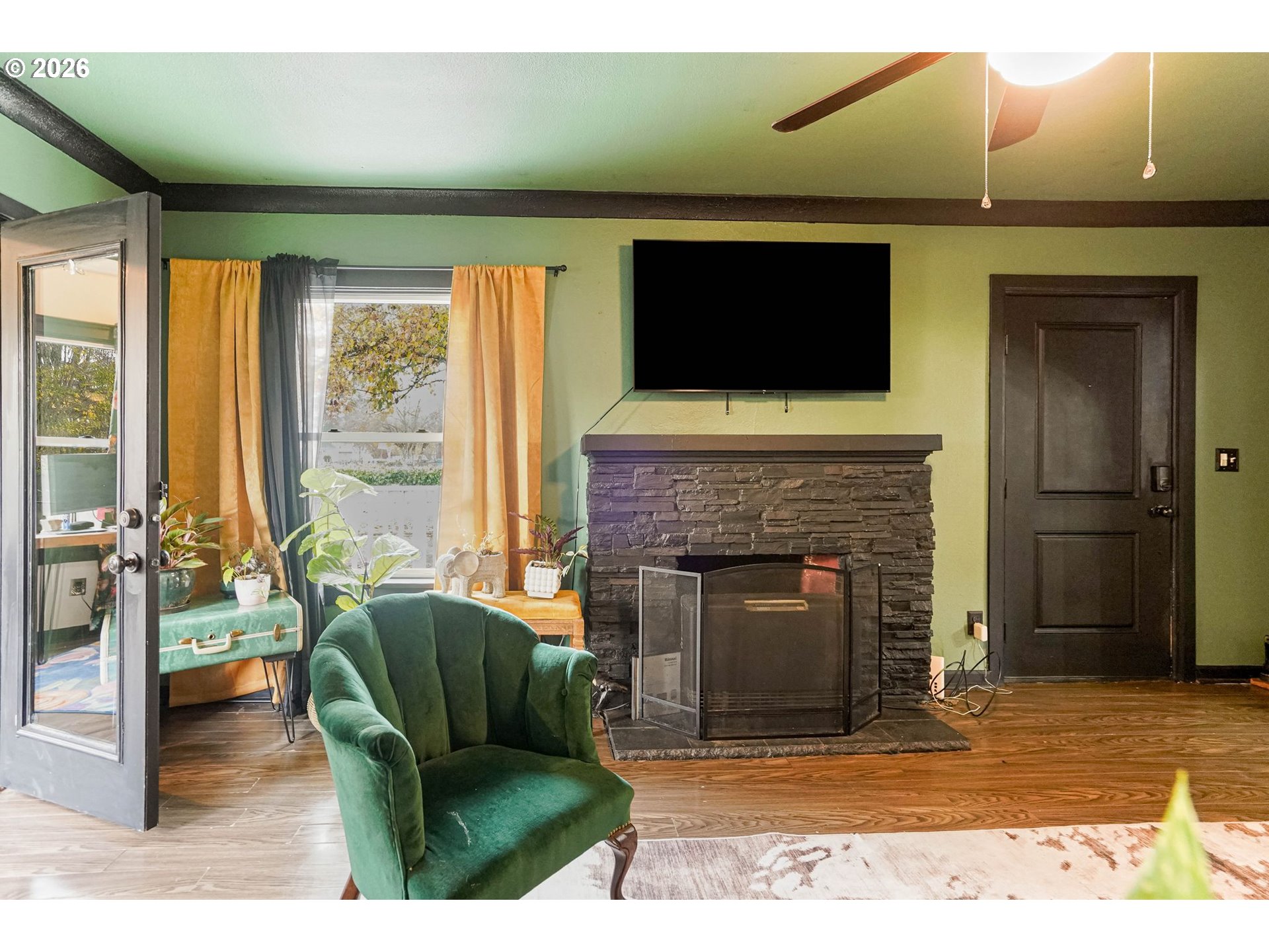 4810 Rickman Road Northeast Keizer, OR 97303 - Photo 20 of 42 a living room with furniture a flat screen tv and a fireplace