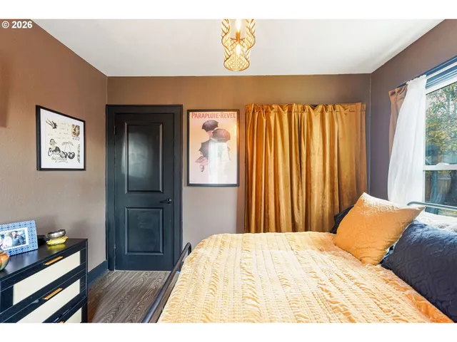 a bed sitting in a bedroom next to a window