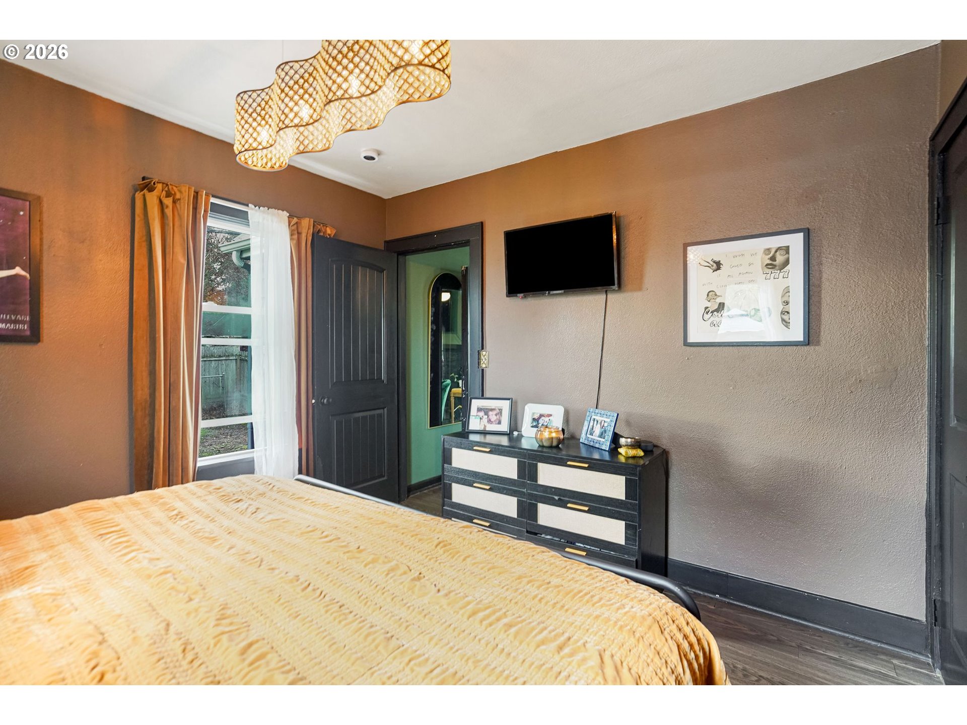 4810 Rickman Road Northeast Keizer, OR 97303 - Photo 25 of 42 a bedroom with a bed and a flat screen tv