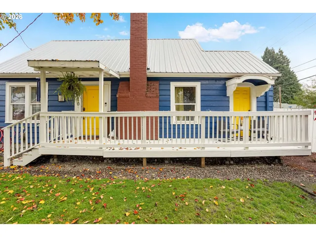 a view of a house with a yard and deck