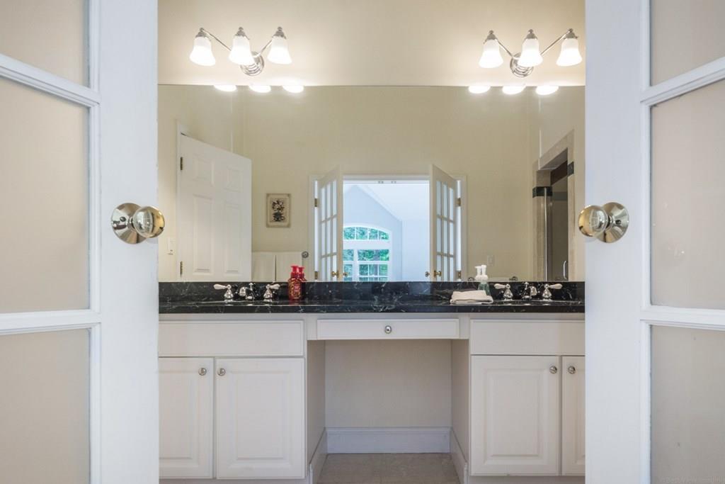 36 Corn Road Bolton, MA 01740 - Photo 17 of 39 a bathroom with a sink vanity and a mirror