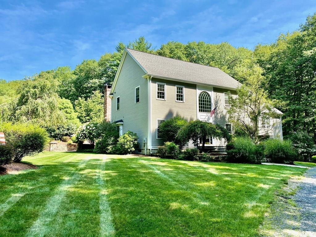 36 Corn Road Bolton, MA 01740 - Photo 2 of 39 a front view of a house with a yard