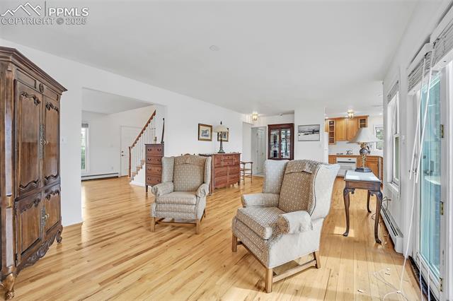 3954 County Rd KK 75 Fowler, CO 81039 - Photo 6 of 41 Living area with light wood finished floors, plenty of natural light, and a baseboard heating unit