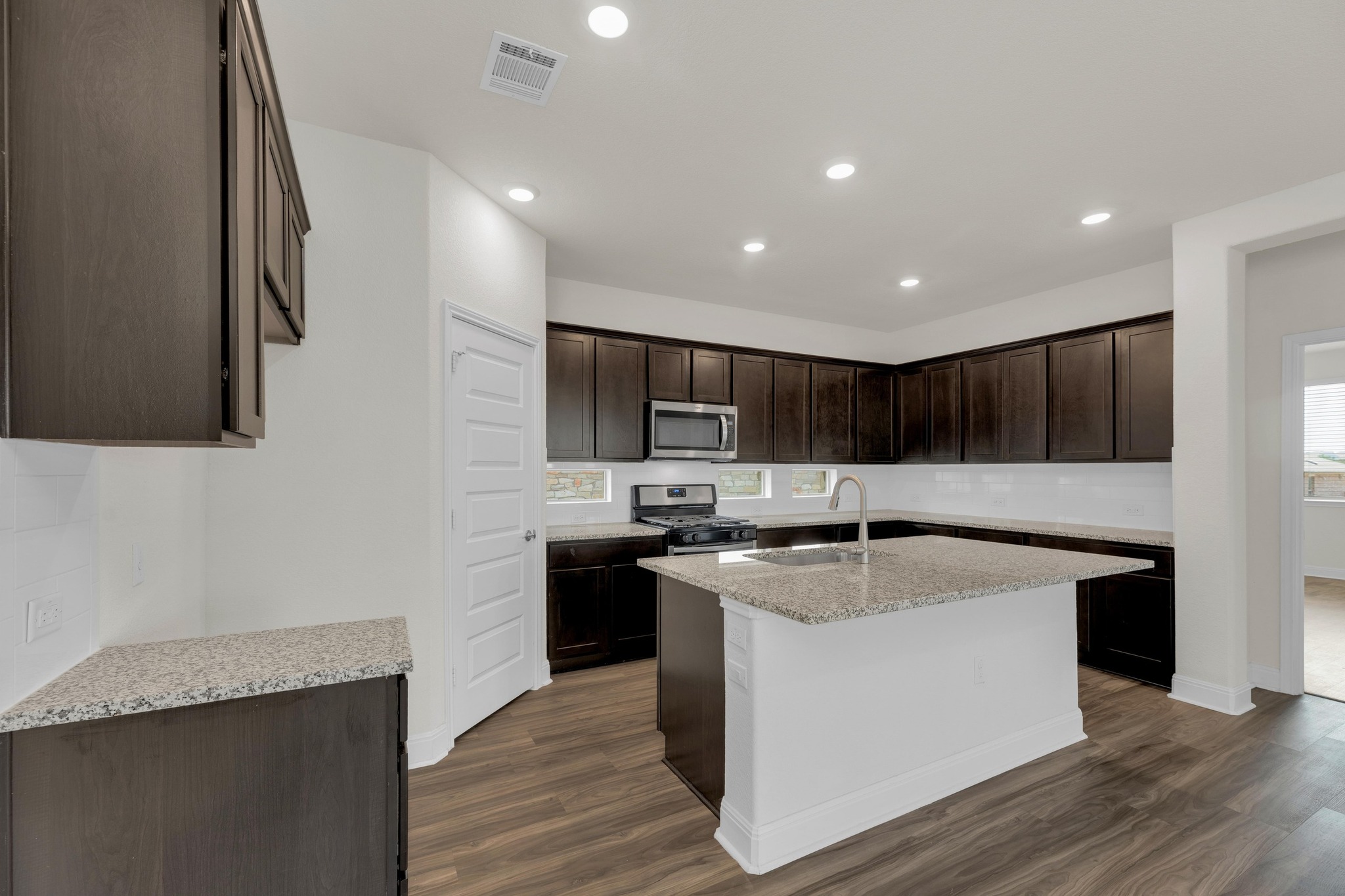 16817 Ponte Cove Pflugerville, TX 78660 - Photo 11 of 36 a kitchen with stainless steel appliances granite countertop a sink stove and refrigerator