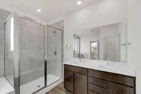 a kitchen with a sink vanity and a mirror