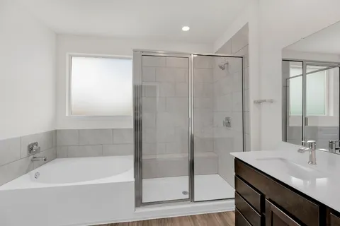 a bathroom with a shower sink and mirror