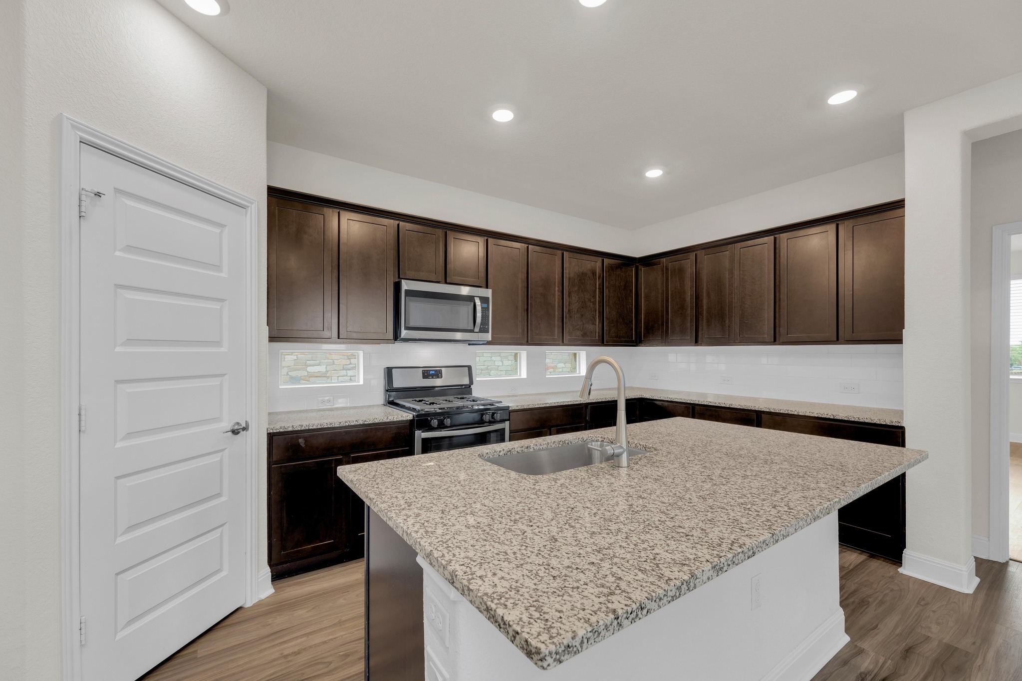 16817 Ponte Cove Pflugerville, TX 78660 - Photo 2 of 36 a kitchen with stainless steel appliances granite countertop a sink refrigerator and cabinets