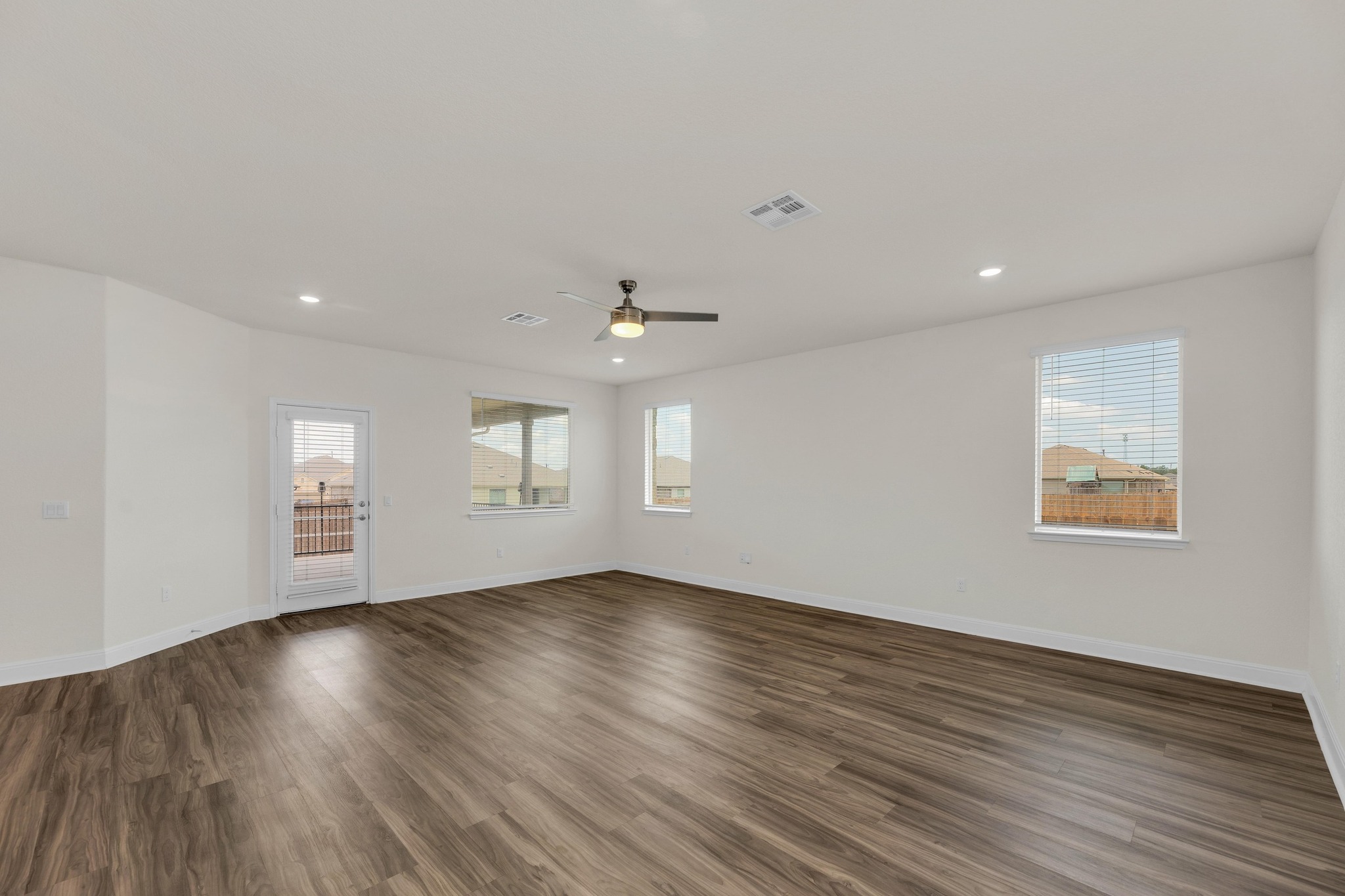 16817 Ponte Cove Pflugerville, TX 78660 - Photo 7 of 36 an empty room with wooden floor and windows
