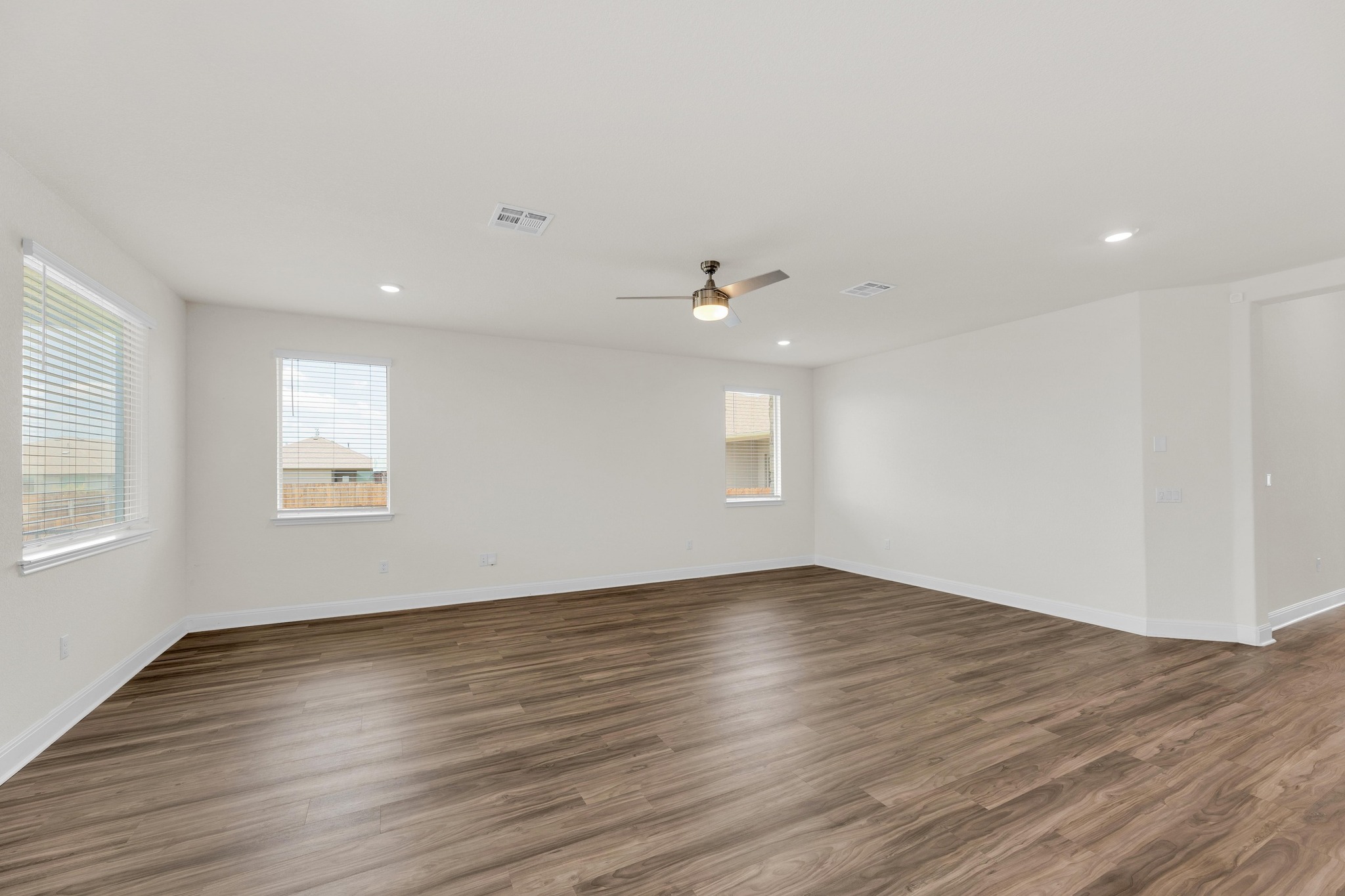 16817 Ponte Cove Pflugerville, TX 78660 - Photo 8 of 36 an empty room with wooden floor and windows