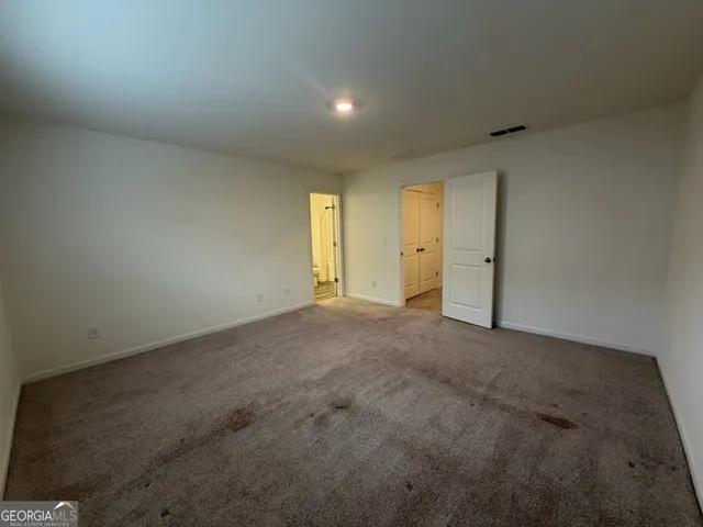 a view of an empty room and a window