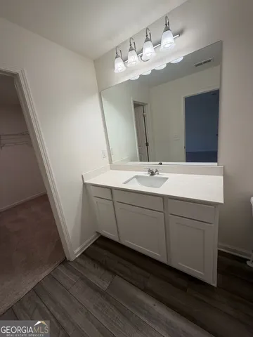 a bathroom with a double vanity sink and a mirror