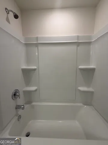 a bathroom with a sink a mirror and a shower