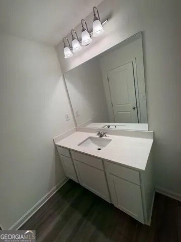 a bathroom with a sink mirror and toilet