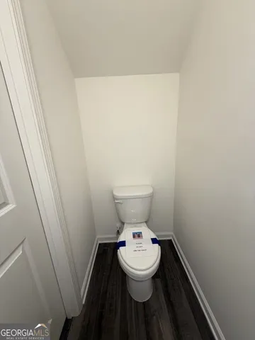a white toilet sitting next to a small sink