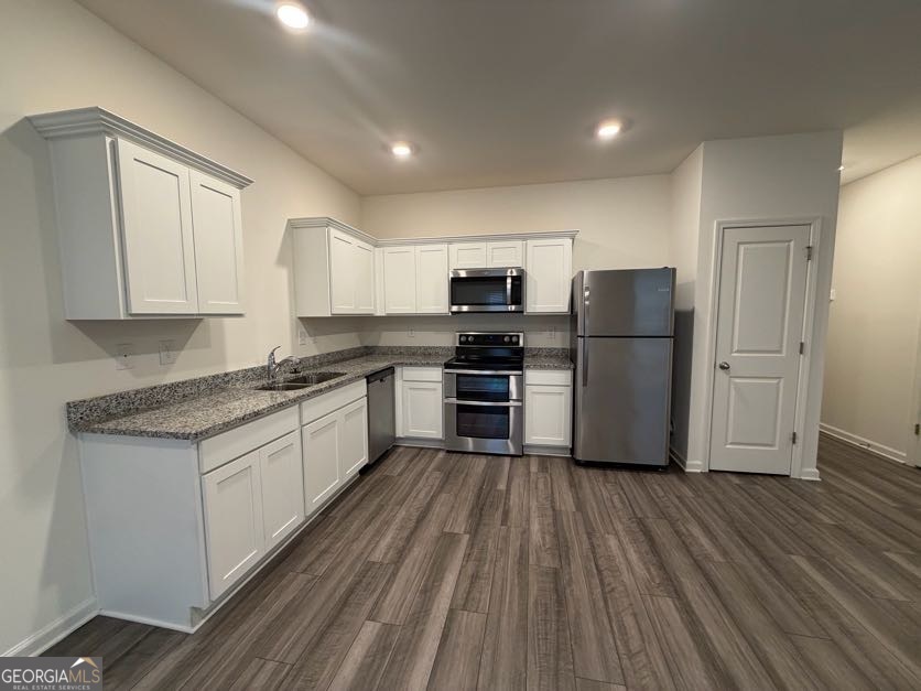 35300 Condor Court Southwest Atlanta, GA 30331 - Photo 10 of 31 a kitchen with a refrigerator a stove top oven and wooden floors