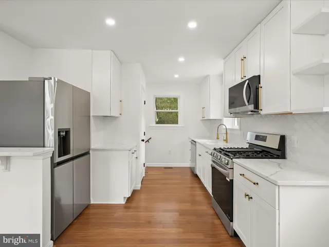 a kitchen with stainless steel appliances a refrigerator stove and microwave