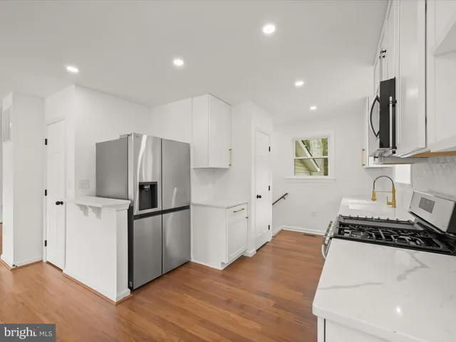 a kitchen with stainless steel appliances a refrigerator stove and microwave