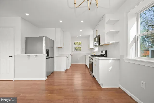 a stove top oven sitting inside of a kitchen