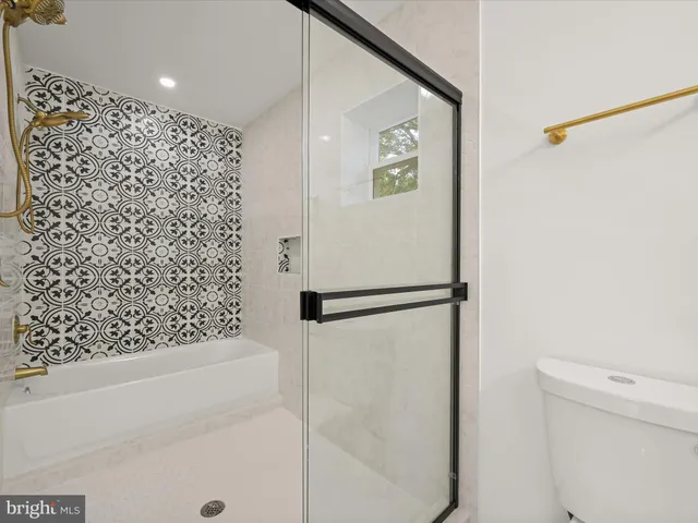 a bathroom with a shower and a toilet