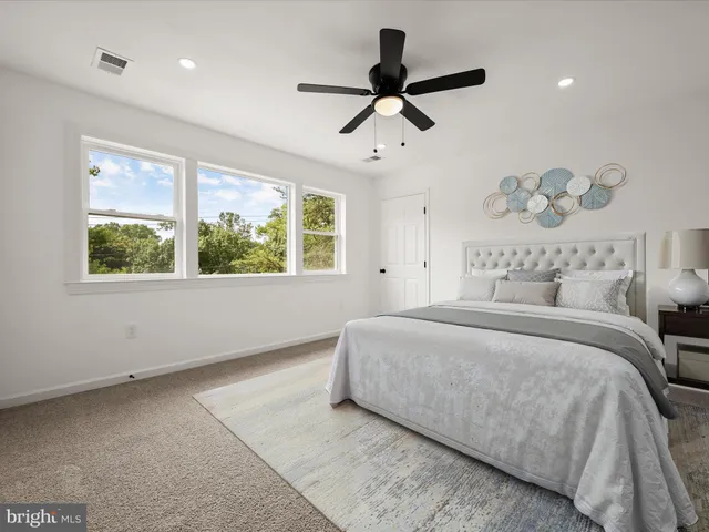 a bedroom with a large bed and a window