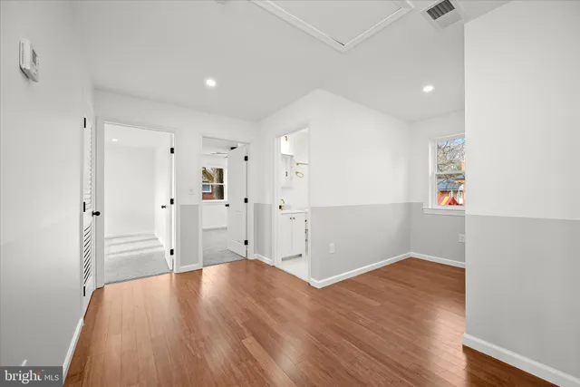 a bathroom with a sink a vanity a mirror and bathtub