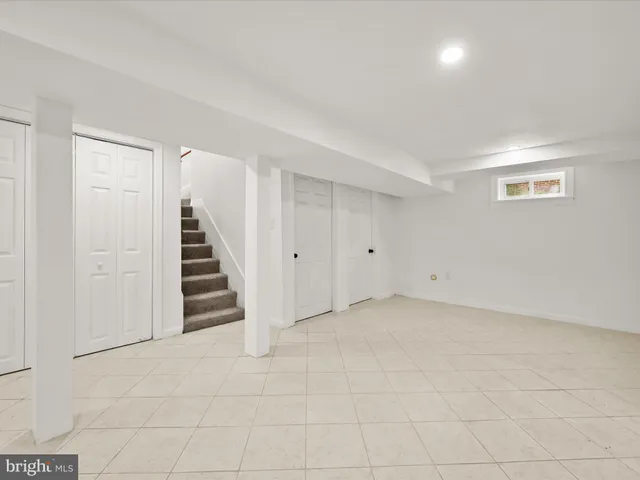 a view of a house with a yard and a large tree