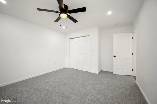 a white house that has a tree in front of it