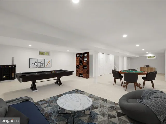 a living room with furniture a rug and a table