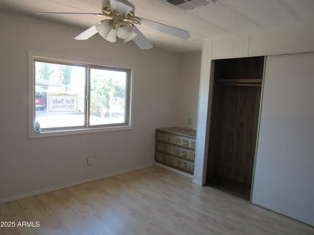 a view of room with a ceiling fan and a window