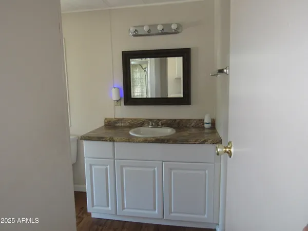 a bathroom with a granite countertop sink and a mirror