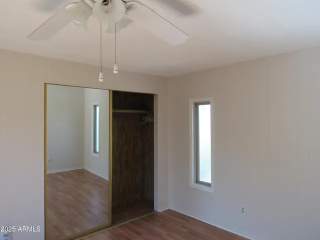 an empty room with windows and closet