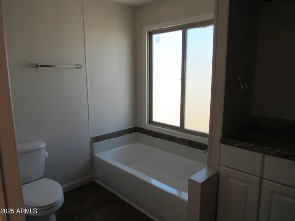 a bathroom with a toilet bathtub and window